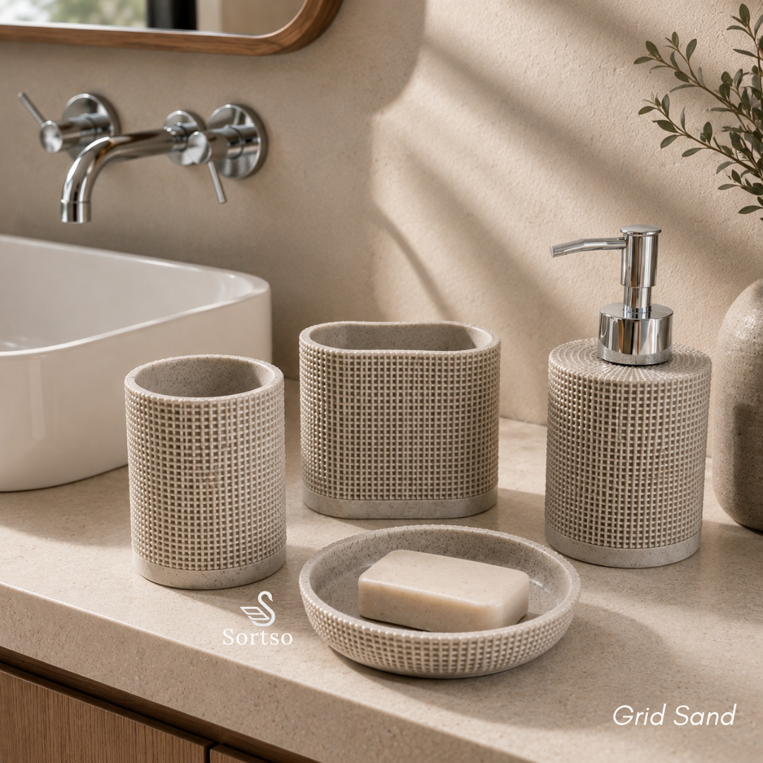 Grid sand 4-piece resin bathroom set with soap dispenser, holders and soap dish beside sink