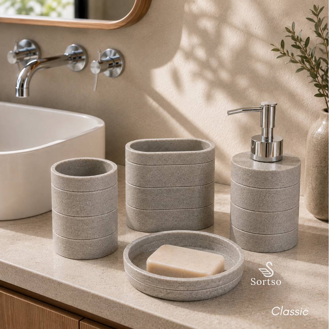 Classic 4-piece resin bathroom set with soap dispenser, holders and soap dish beside sink