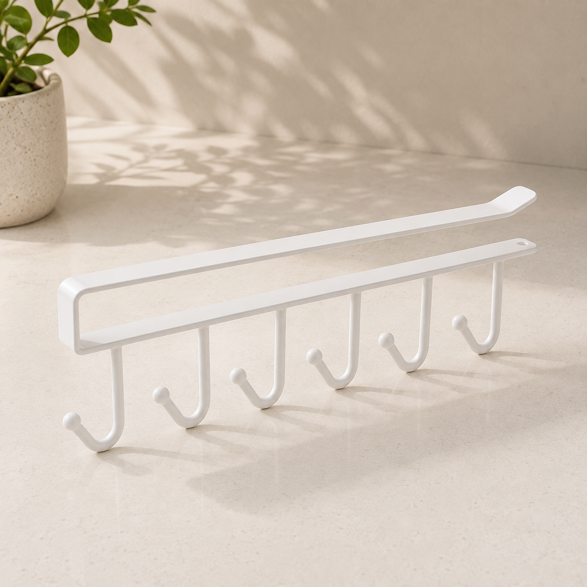 White under-shelf mug holder with 6 hooks for hanging cups and mugs.