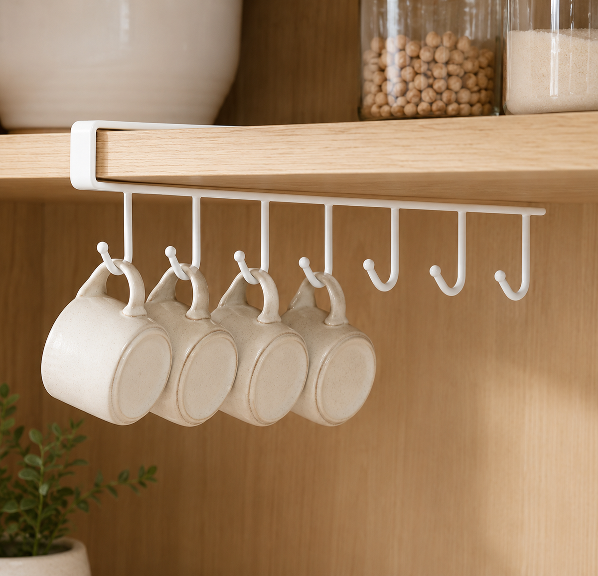 Under-shelf mug holder installed on a wooden shelf with mugs hanging from the hooks