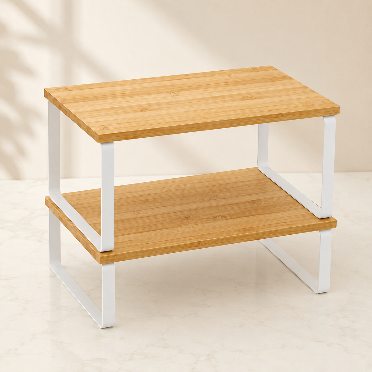 Stackable bamboo cabinet shelf risers with white metal frames, shown stacked together.