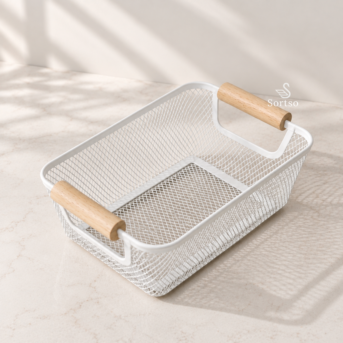 Metal mesh desktop organizer with wooden handles on a neutral countertop