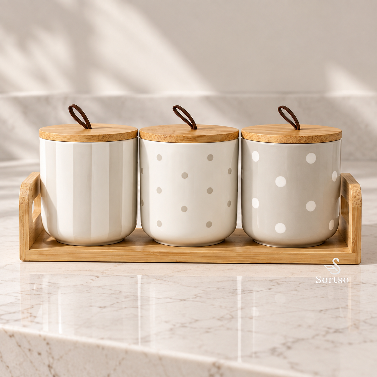 Set of three ceramic kitchen canisters with bamboo lids and wooden tray