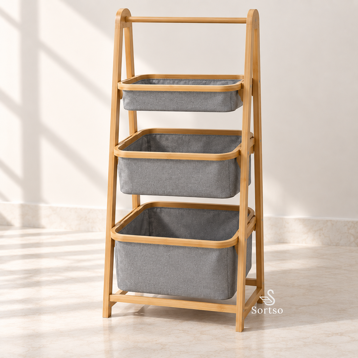 3-tier bamboo laundry sorter with three grey fabric storage baskets.