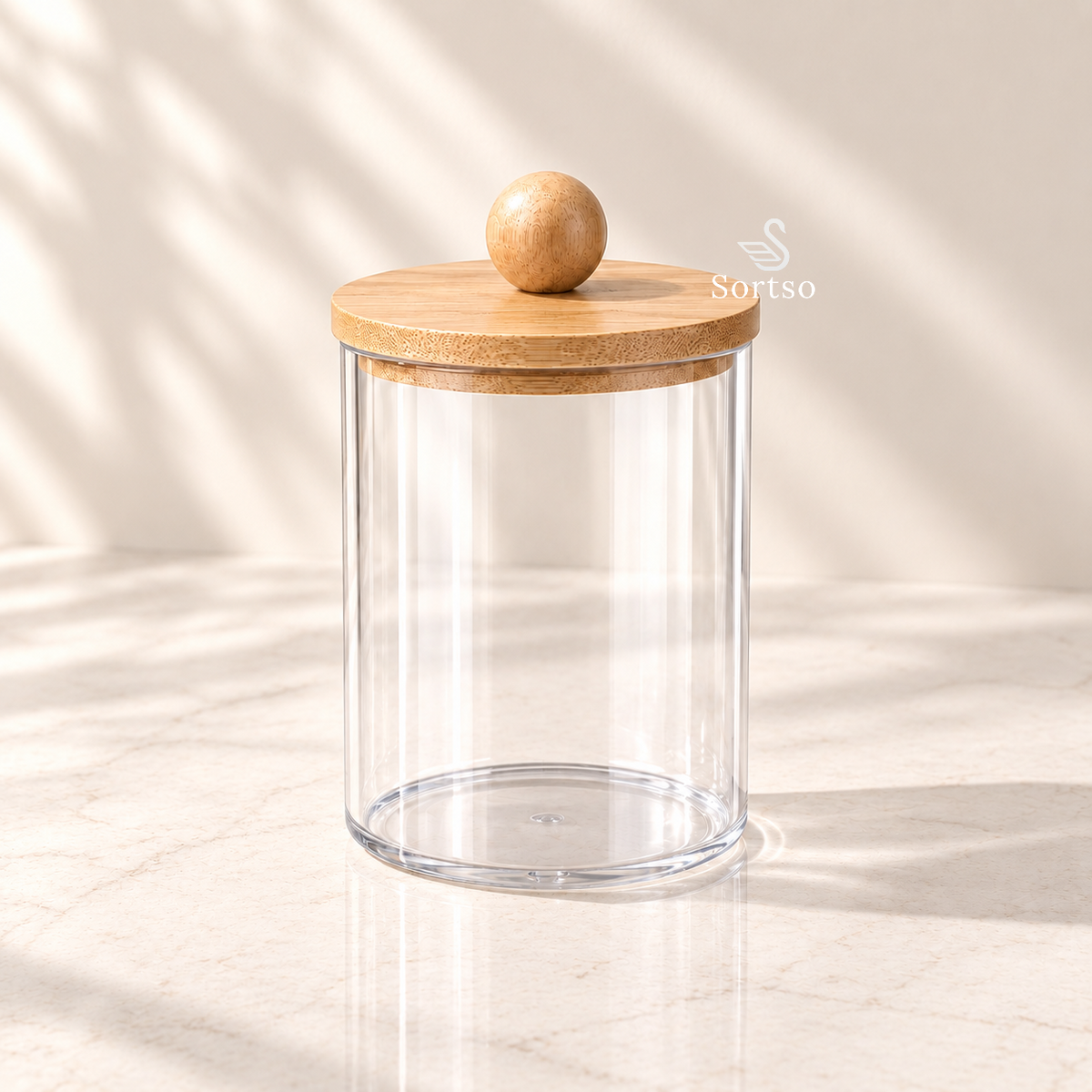 Clear vanity storage jar with bamboo lid and wooden knob.